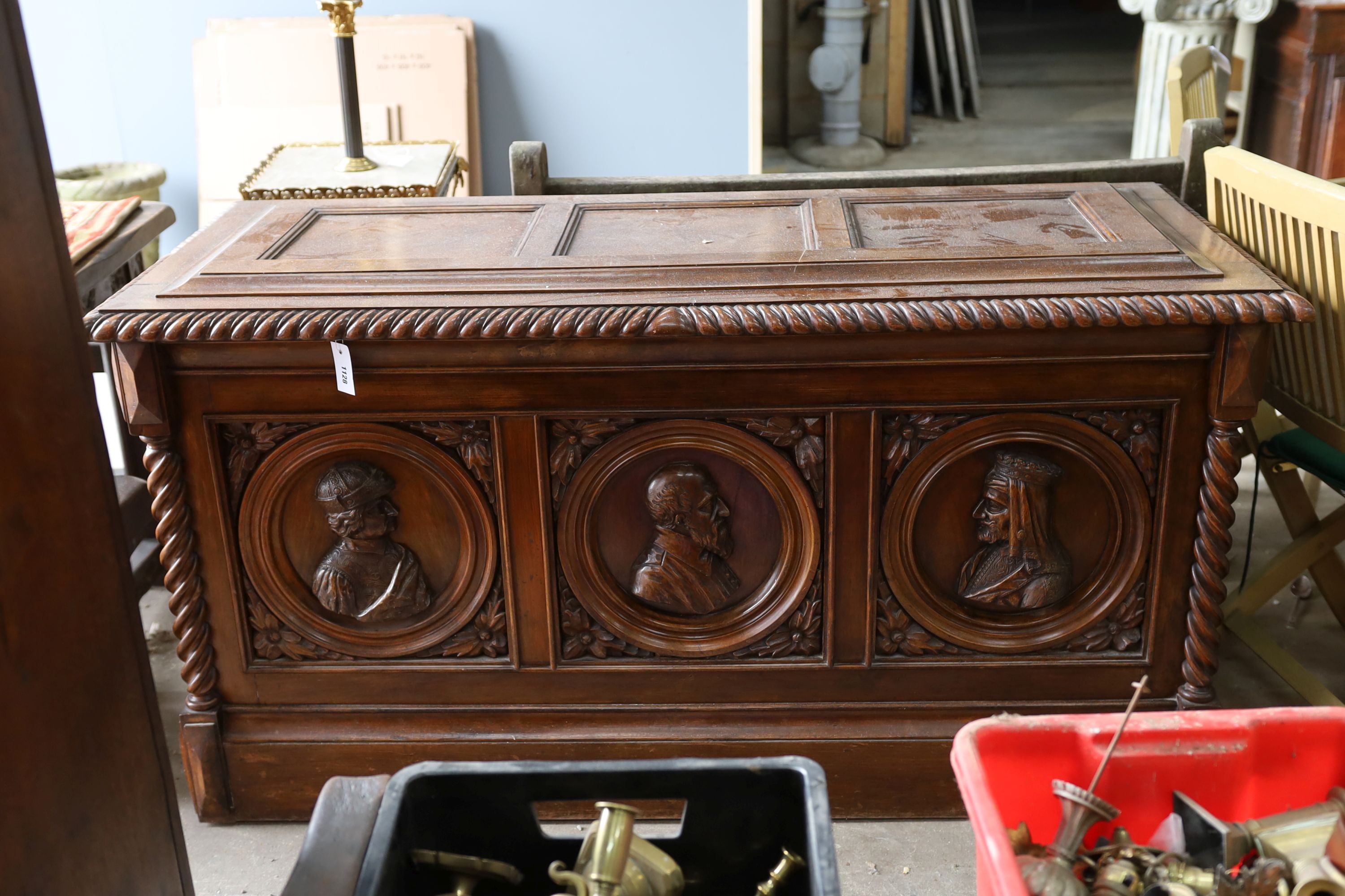 A 17th century style walnut cassone carved with busts in relief, width 160cm, depth 70cm, height 84cm